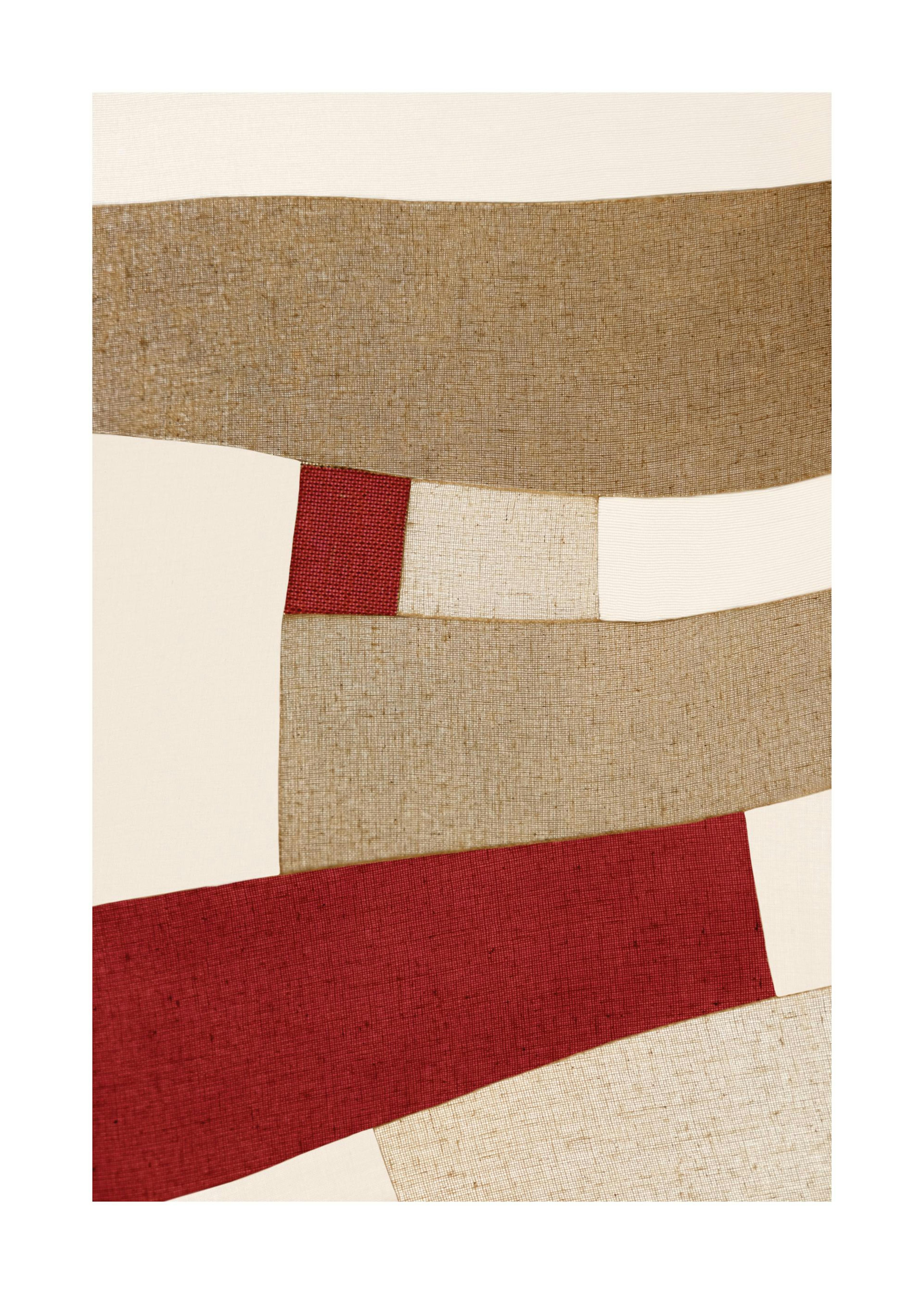 Red and beige abstract patchwork print with linear fabric textures, creating a modern visual effect.